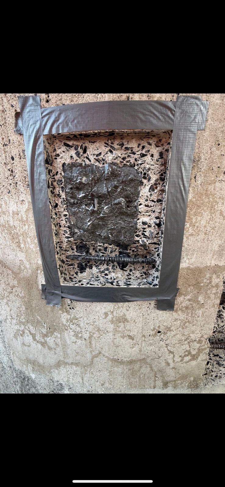 Cut-out concrete repair mockup with exposed rebar at the New York State Pavilion observation towers