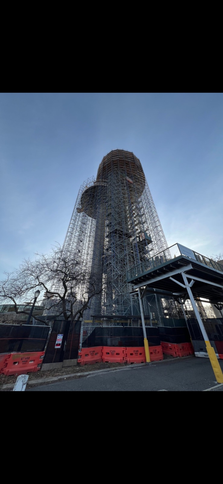 New York State Pavilion observation tower fully enclosed in scaffold during concrete restoration, Flushing Meadows-Corona Park, Queens